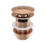 Rose gold-colored drain plug with Krysstal logo on a white background