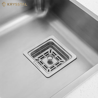 Stainless steel kitchen sink with drain and Krysstal logo