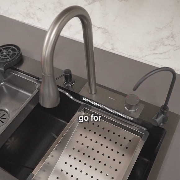 Video of stainless steel kitchen sink with built-in cutting board, modern faucet, and accessories displayed on a white surface.